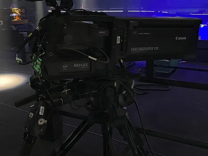 Broadcast camera with Canon lens on a tripod